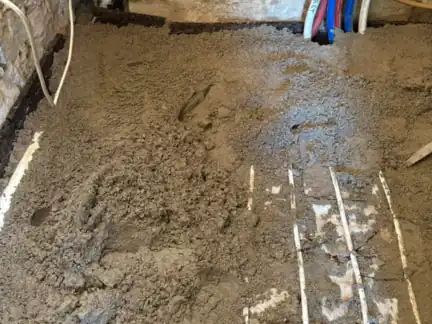 Screed going down over the heating pipes, JAM Floor Screeding